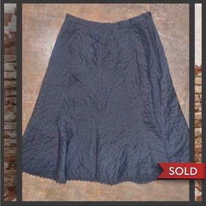 Classic gothic cottagecore black eyelet lace textured patterned midi skirt.